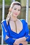 Slim brunette broad in a blue dress unveils her cleanly shaved fur pie