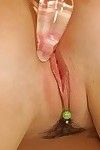 Nude blonde knockout with pierced clit playing with a glass anal vibrator