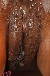 Cute ebony babe Jasmine pours a lot of oil into her anal crack slit