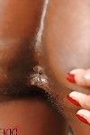 Cute ebony babe Jasmine pours a lot of oil into her anal crack slit