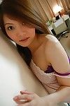 Chinese pretty undressing and exposing her damp unshaved bawdy cleft in close up