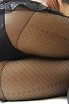Eastern MILF in hose undressing and exposing her hirsute vagina in close up