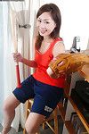 Brown hair Oriental youthful Yumi teases her juvenile wet crack with a bat