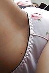 Smiley Japanese cutie getting bare and exposing curly gash in close up