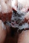 Oriental young delightsome bathroom and exposing her soapy cage of love in close up