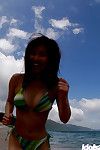 Rounded oriental princess Adusa Kyono slipping off her bikini outdoor