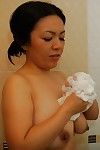 Boobsy Chinese MILF admirable bathroom and rubbing her soapy cage of love in close up