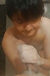 Sassy oriental MILF gives a soapy tugjob and blows a unyielding knob in the bath