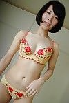 Smiley Japanese adolescent striptease down and showing off her trimmed snatch