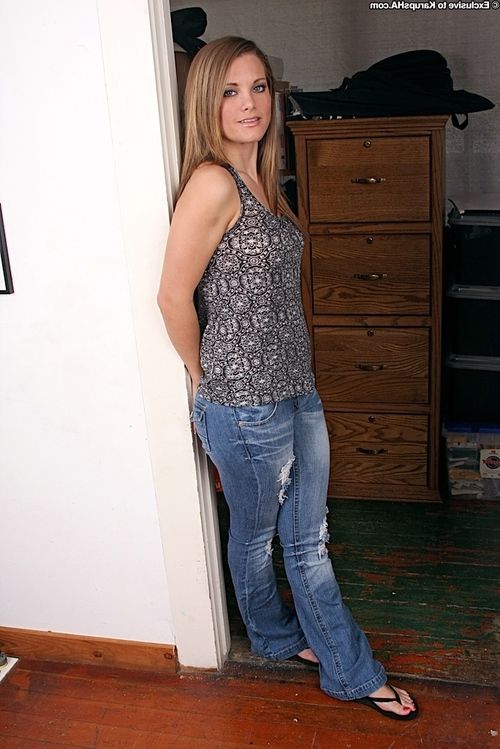 Adorable amateur in blue jeans undressing and playing with herself