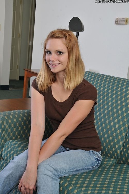 Gorgeous teen beauty Brittny is showing her tight pussy on a couch