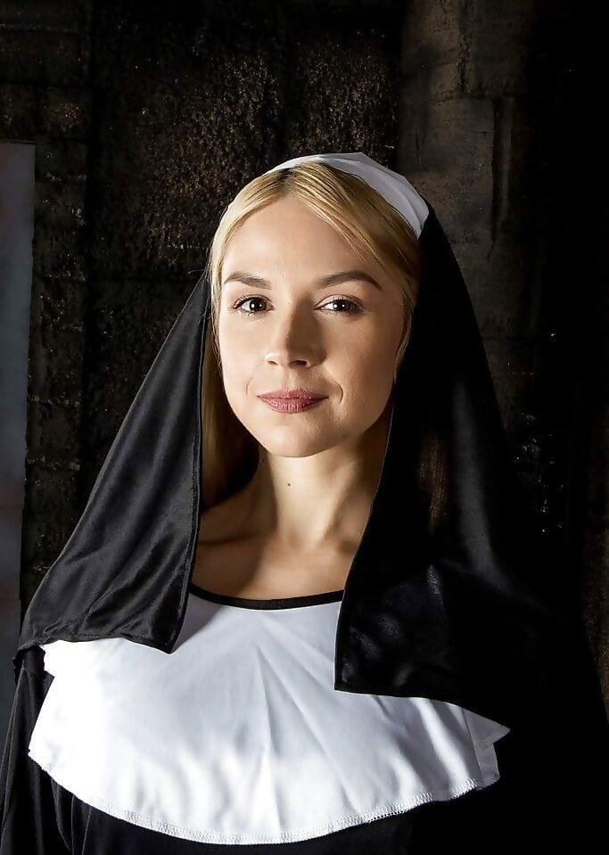Blonde babe Sara Sloane strips off nuns uniform to expose big tits