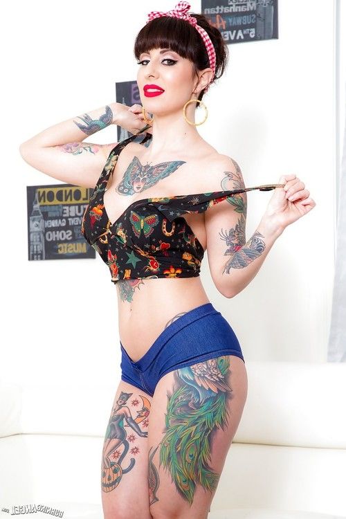 Long legged tattooed MILF Dollie Darko undressing to show spread ass