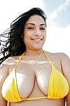 Naughty babe in bikini Rikki Nyx showcasing her big tits outdoor
