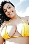 Naughty babe in bikini Rikki Nyx showcasing her big tits outdoor