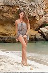 Wet beach babe Dominika A exhibiting sexy teen legs during glamour shoot