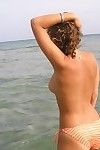 Sweet young girl shows her nice boobs on public beach