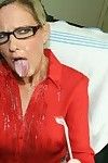 Fully clothed mature blonde in glasses gives a handjob and gets bukkaked