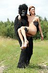 Sexy redhead cosplay chick Becca romps nude outdoors in heels with gorilla