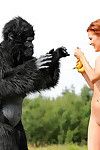 Sexy redhead cosplay chick Becca romps nude outdoors in heels with gorilla