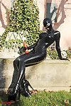Fetish babe Lucy Latex posing and masturbating her cunt outdoor