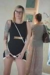 Tattooed female Emma Mae revealing bald vagina underneath black dress