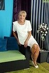 Clothed granny Janet Lesley revealing saggy tits while undressing
