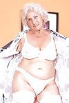 Blond granny in shiny white stockings denudes boobs and masturbates