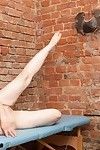 Fit girl stretching before a fetish speculum inspection