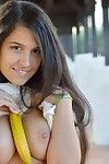 Lovely brunette cutie stuffs a banana in her tight hairy pussy