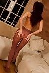 Redhead in pantyhose stripping off her clothes