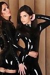 Two hot models posing in the most skin tight of shiny black late