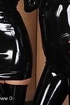 Two hot models posing in the most skin tight of shiny black late