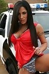 Latina milf is taking off top lingerie posing outdoor near police car