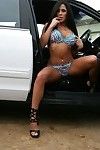 Latina milf is taking off top lingerie posing outdoor near police car