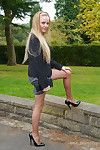 Cute blonde is outdoors in tall black high heel shoes and sexy n