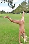 Sexy blonde girl shedding spandex pants and top to pose nude in public park