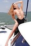 Busty pornstar Cindy Hope strips off her dress and poses on a boat