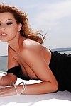 Busty pornstar Cindy Hope strips off her dress and poses on a boat