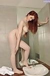Ample-breasted redhead sweetie taking off her pantyhose in the bathroom