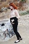 Redhead punk chick Nicci Vice showing off natural tits in forest