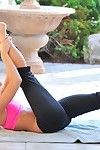 Flexible blonde looker in yoga pants spreads her long legs outside