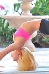 Flexible blonde looker in yoga pants spreads her long legs outside