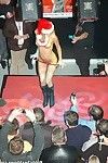 Adorable blonde girl stripping off the santa coat on the stage