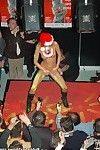 Adorable blonde girl stripping off the santa coat on the stage