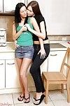 Two smoking hot teens enjoy lesbian strapon sex right in the kitchen