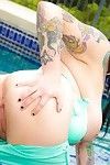 Busty tattooed babe scarlet lavey naked in the pool