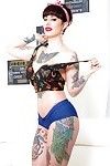 Long legged tattooed MILF Dollie Darko undressing to show spread ass