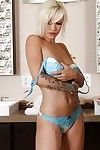 Frisky blonde doxy slowly uncovering her stunning tattooed curves