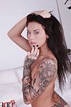 Busty tattooed hottie with pierced nipple getting rid of her clothes